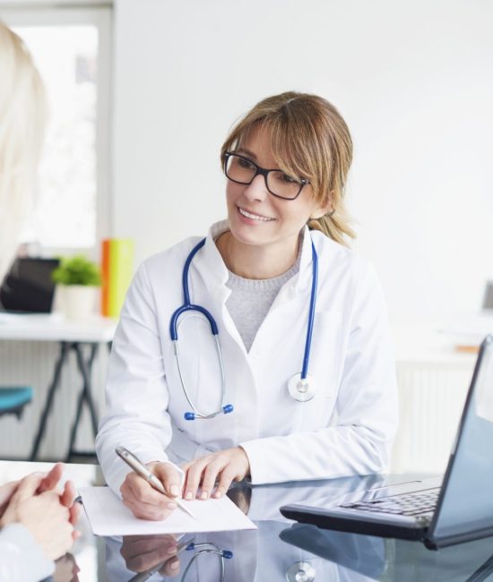 Shot of a middle aged female doctor sitting in front of laptop and consulting with her patient.